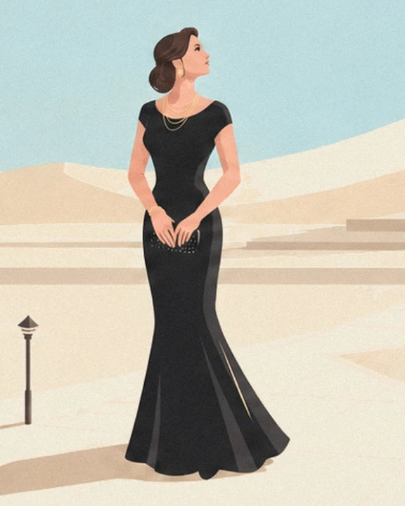 A woman in a long black dress with gold necklaces and a clutch bag, in front of pale steps