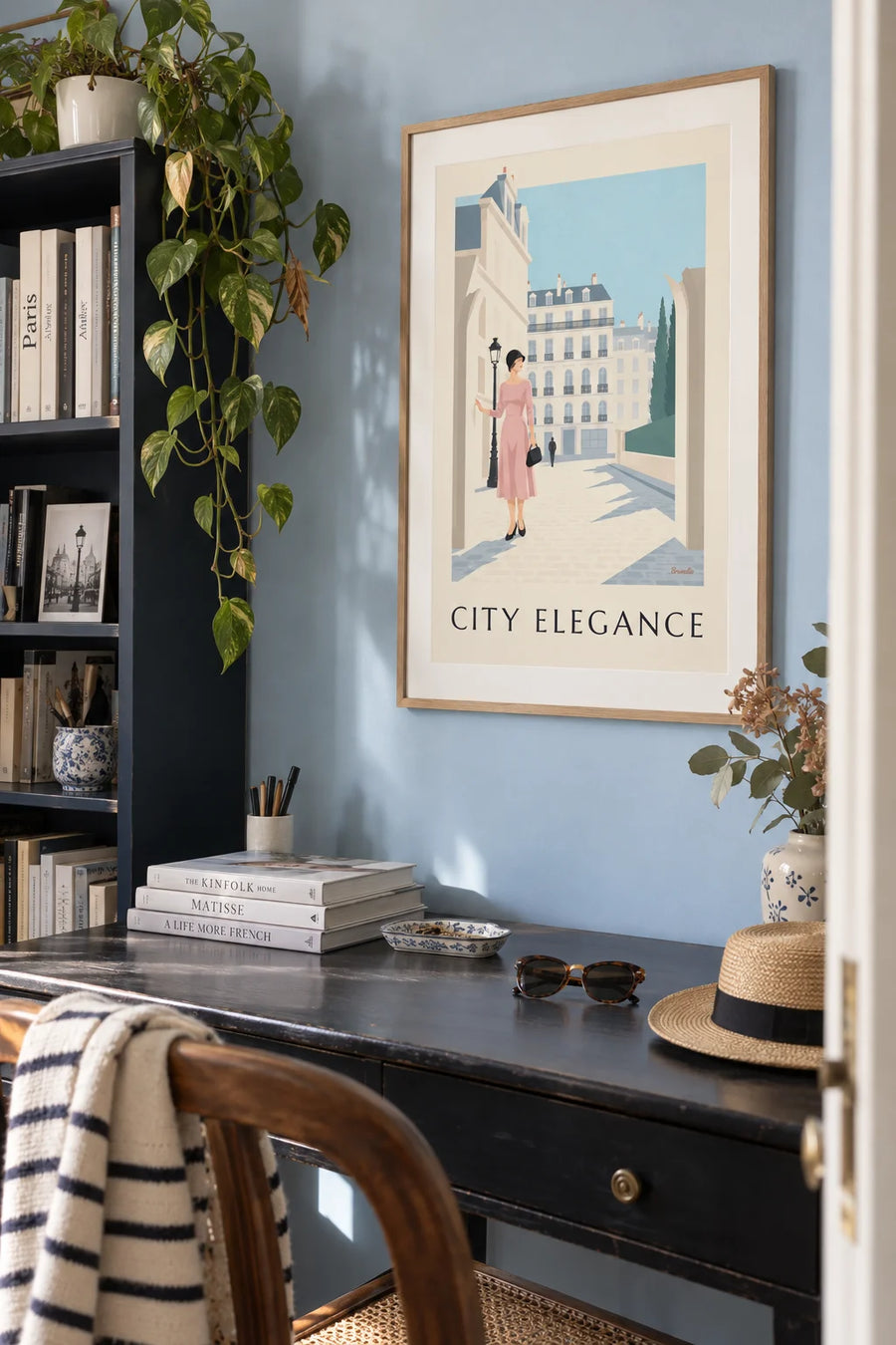 Poster of a refined woman in front of a city façade in black and pastel: framed on the wall