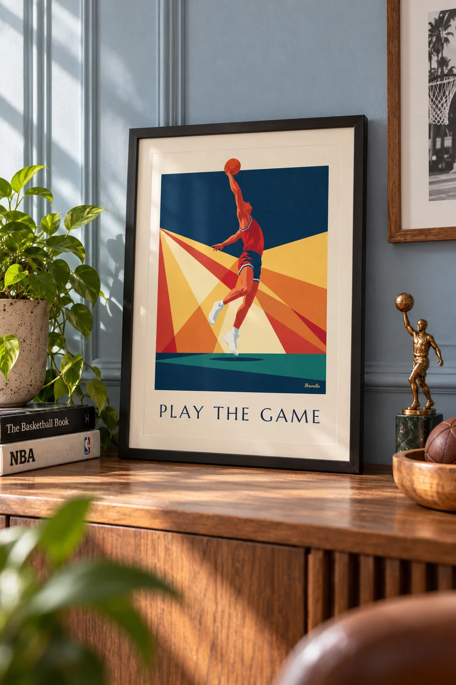 Poster of a basketball player mid-dunk against a backdrop of rays: small framed A4 size