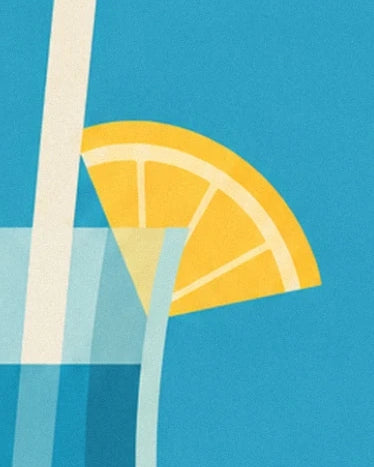 Una fetta di limone giallo sul bordo del bicchiere blu accanto a una cannuccia chiara