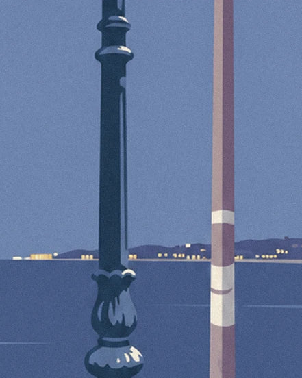 The street lamp and its striped post facing the bay, with coastal lights in the distance