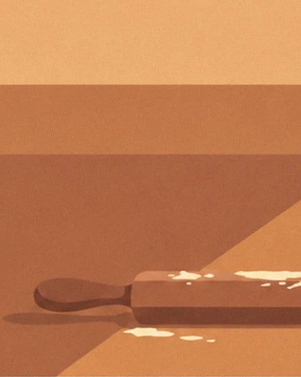The wooden rolling pin with traces of flour, lying in a shaft of light