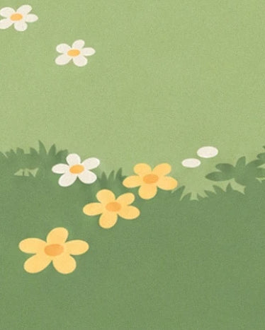 Des fleurs blanches et jaunes éparpillées dans une herbe aux nuances de vert