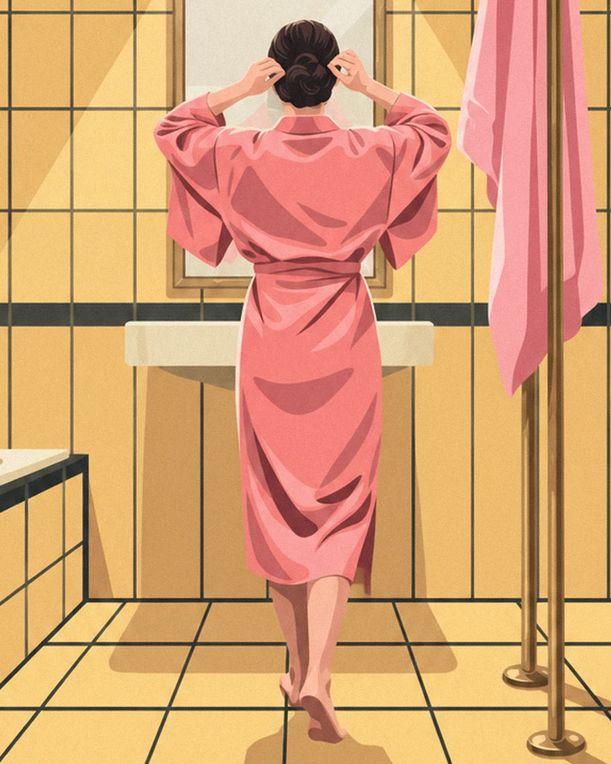 A woman seen from behind in a pink dressing gown at the washbasin, against yellow tiles