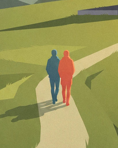 The couple in blue and orange jackets walking along the dirt path between the meadows