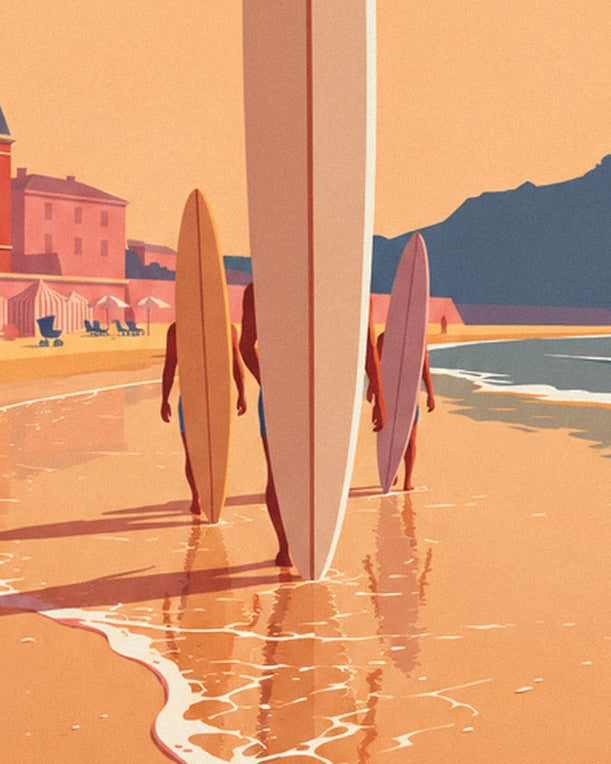 Surfers seen from behind in shallow water, with yellow and pink boards held upright and the beach at Biarritz in the background