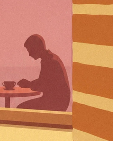 The silhouette of a customer seated in front of their cup, near the golden millefeuille