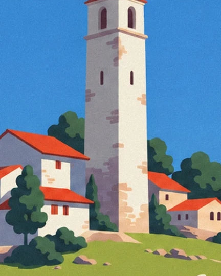 The tall pale stone tower among red-roofed houses and trees