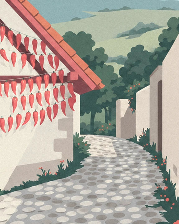 The cobbled lane between white walls, with dried chillies beneath the tiled roof