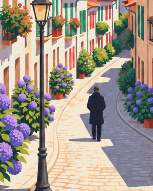 A man in a dark coat walking down the cobbled lane, between hydrangeas and a street lamp