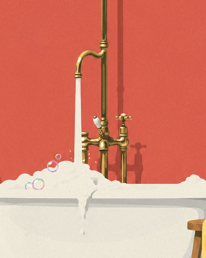 The golden brass tap and its trickle of water making the foam overflow, against a red wall