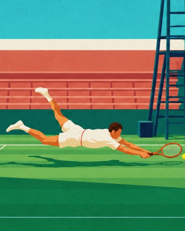 The tennis player in white diving with his racket stretched towards the ball