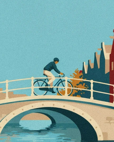A cyclist in a blue jumper crossing the white arched bridge, above the water