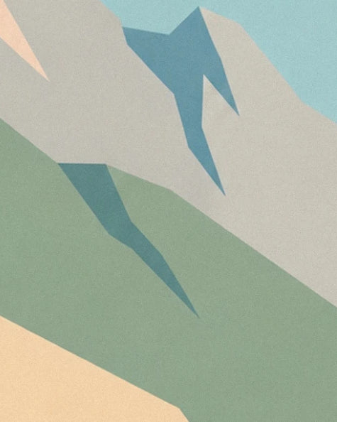 The pale grey rock faces and their blue shadows above a soft green slope