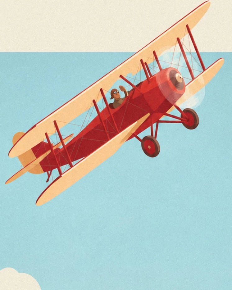 The red biplane with cream wings and its pilot in the blue sky