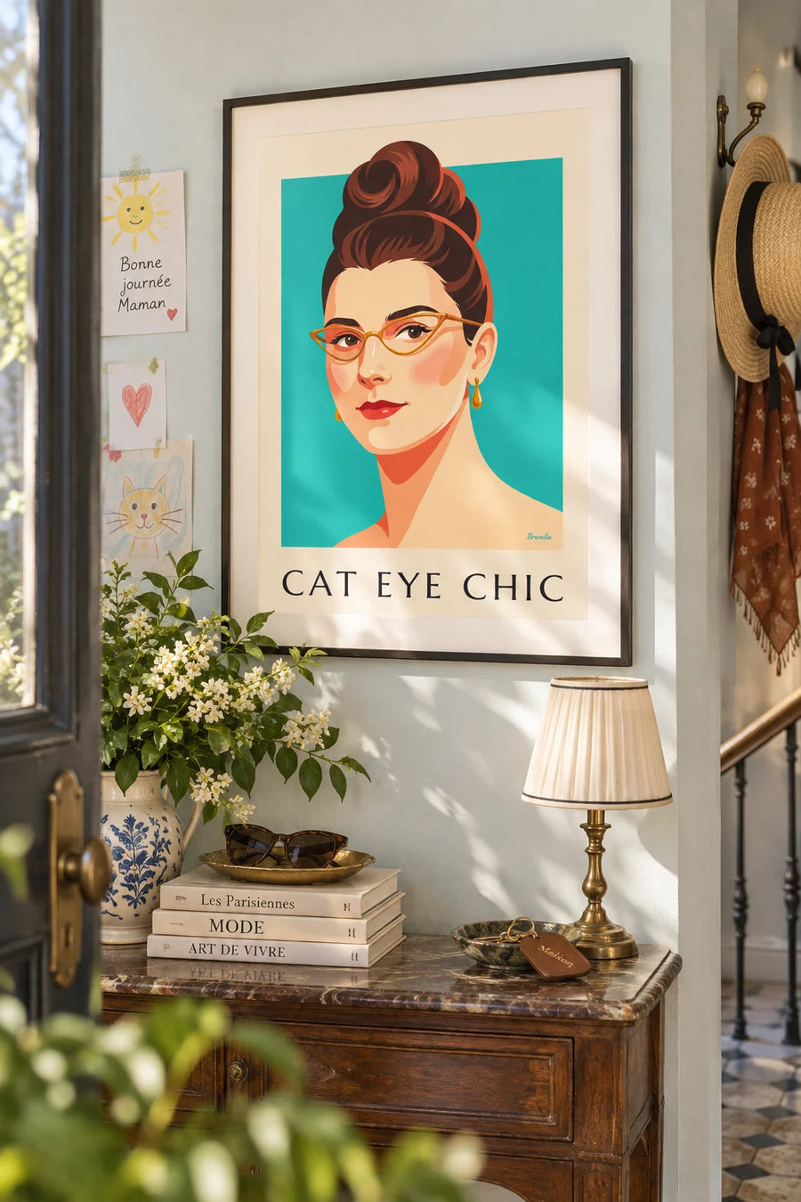 Poster of a woman’s portrait with cat-eye glasses and red lips: framed on the wall