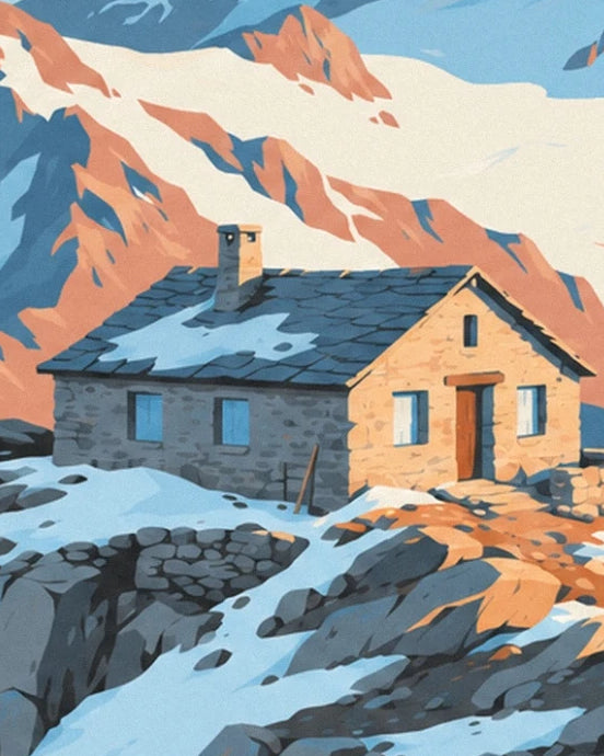 The stone mountain hut with its snow-covered slate roof, surrounded by orange rocks