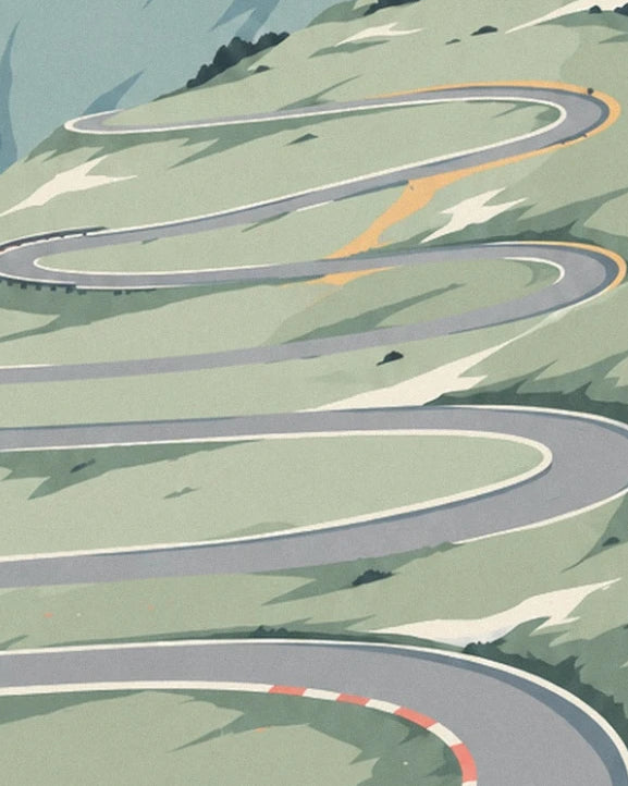 The hairpin bends of the grey road on the green slopes of the Stelvio