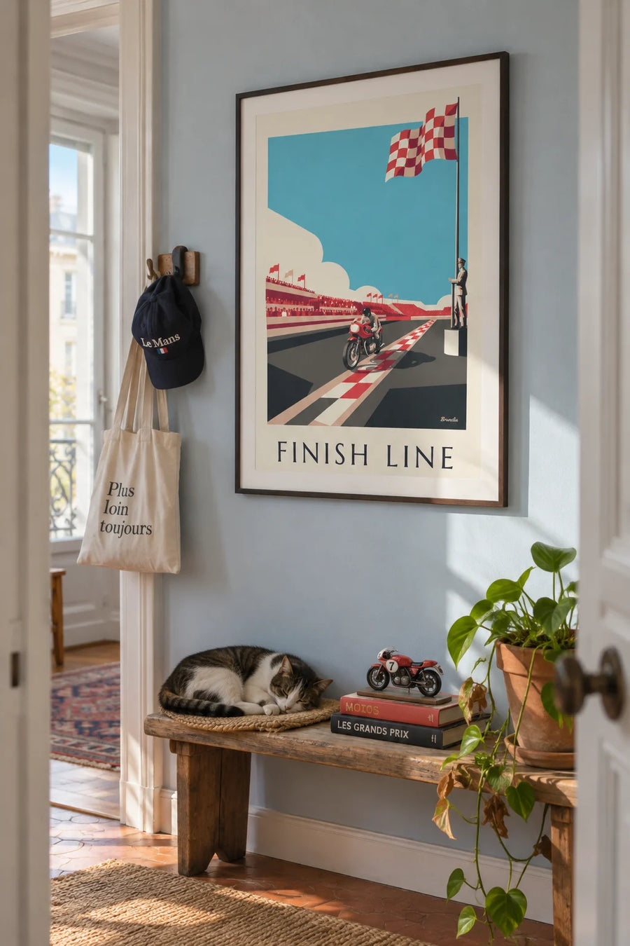 Poster of a motorcycle crossing the finish line under the checkered flag: framed on a wall