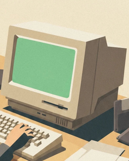 Il computer beige con lo schermo verde e la tastiera sotto la mano dell'utente