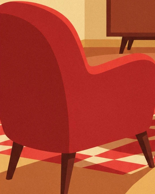 Le fauteuil rouge aux formes arrondies sur le tapis à motifs géométriques
