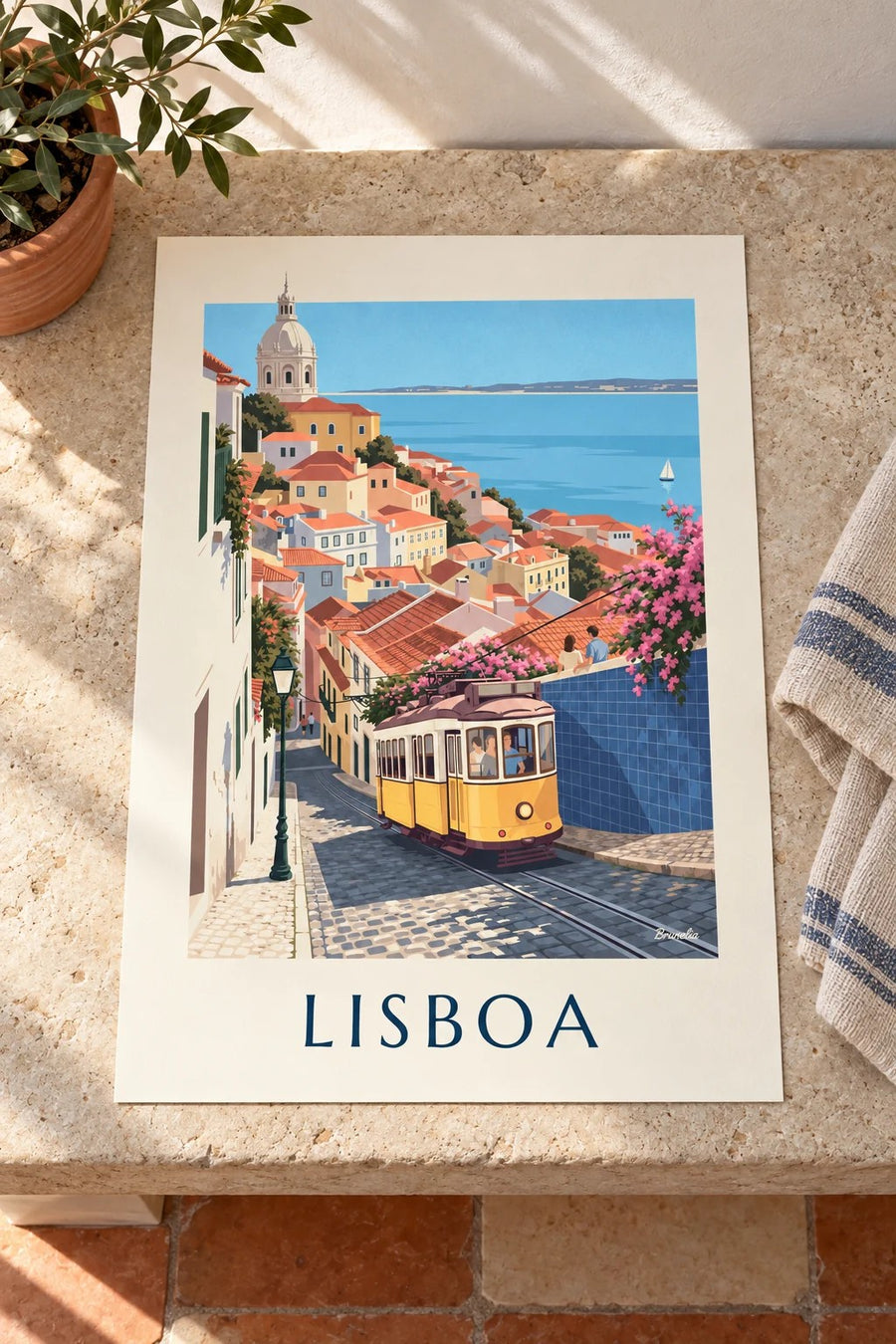 Poster tram giallo in una strada acciottolata di Lisbona di fronte al Tago: appoggiato su un tavolo