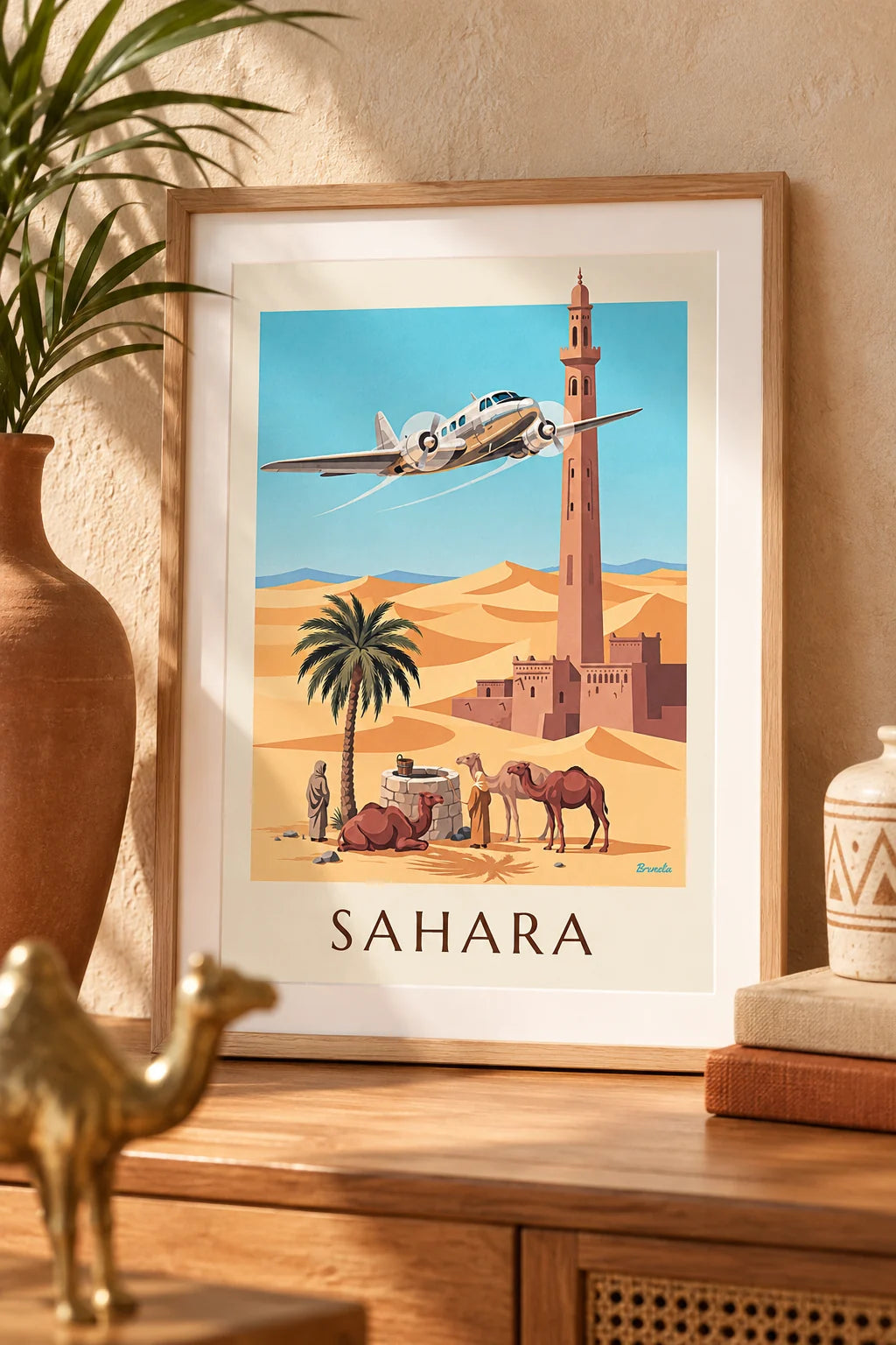 Office: Trimotor plane over a Sahara oasis and dunes poster on the wall